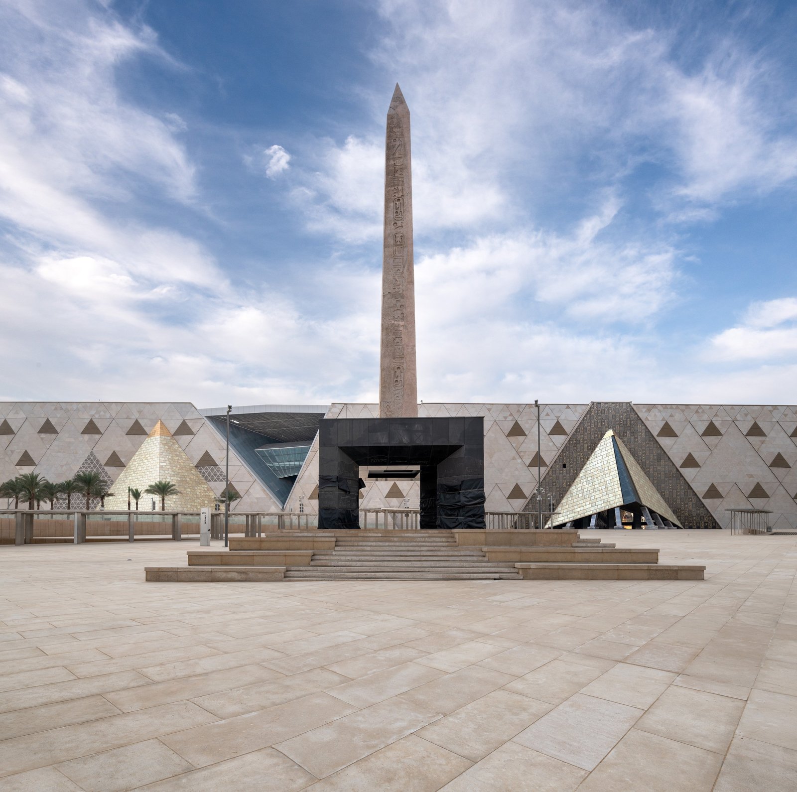 The stepped façade clad in translucent alabaster panels referencing Egypt’s traditional materials.